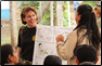 photo thumbnail: CDR Kimberly Elenberg, a nurse officer, provides an illustration of proper hand-washing practices to a group of women as part of Operation Continuing Promise.