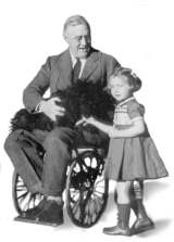 Photo of  President Roosevelt (FDR) in a wheelchair with his dog and a young girl.