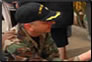 Photo Thumbnail: While in Peru as part of Operation Continuing Promise, CDR John Eckert, a scientist, greets a pediatric patient at a clinic.