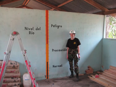 LT Jill Shugart, an Environmental Health Officer, analyzes flood water depths during a school inspection in El Higurel, Guatemala.