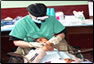 Photo Thumbnail: While at the Huacho clinic, LT Sheila Weagle, a dental hygienist, performs an oral exam on a pediatric patient.