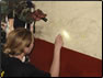 Photo Thumbnail: LT Jill Shugart, an Environmental Health Officer,  conducts a surface lead test of paint at Escuela, Guatemala.