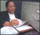 Woman reviewing and filing documents