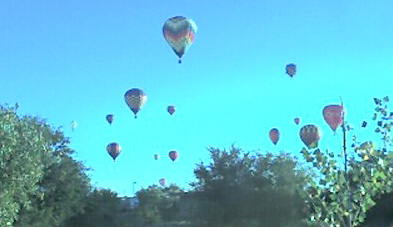 hot air ballons dotting the sky