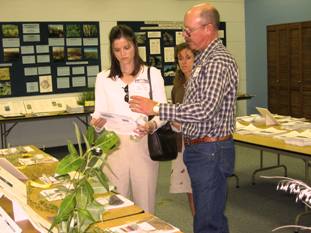 Senator Mike Crapo, staff members, Karen Brown and Laura Thurston Goodroe discuss plant varieties on display with PMC Team Leader, Loren St. John.