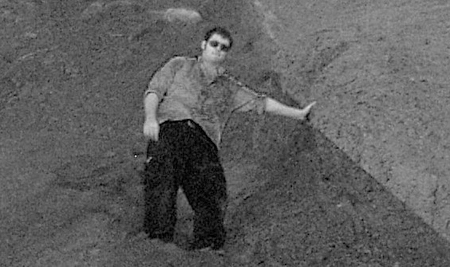 Young man in gravel surroundings