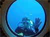 Karen Nyberg in diving gear waving underwater