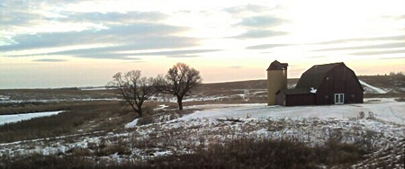 Winter view of a barn and farmland