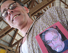 Angled photo of a man with a distorted photo of himself pinned to his shirt