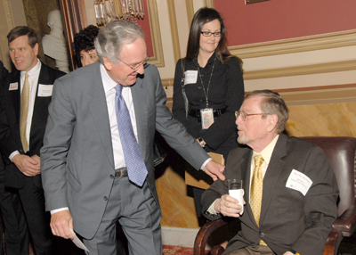 Senator Harkin (left) speaks with Senator Domenici while Beth Stein, Legislative Assistant to Senator Harkin, looks on.