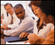 Image of people working in a group.