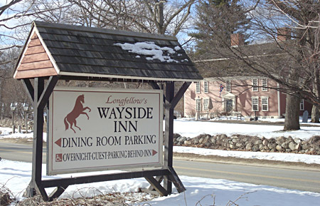 Sign for Wayside Inn in foreground, the Inn across the street