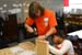 Deputy Assistant to the President and Director of USA Freedom Corps Desiree T. Sayle volunteers with a student on a service project at Watkins Elementary School in Southeast Washington, D.C. on Thursday, September 30, 2004.