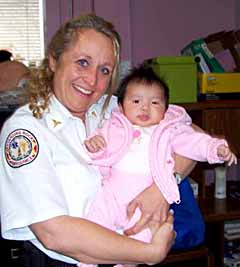 EMSC worker holding a baby