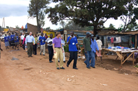 Participants in a site visit to Reach-Out Mbuya Kinawataka Clinic are photographed en route to a home-based care visit. Photo by Arne Clausen.