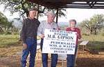 Jim Odiorne, presents a Conservation Rancher award to Mr. and Mrs. M. B. Gipson for their outstanding conservation efforts.