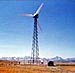 Photo: wind turbine w/vividly colored sunset in the background.