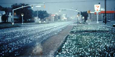 Large hail covers this deserted street.