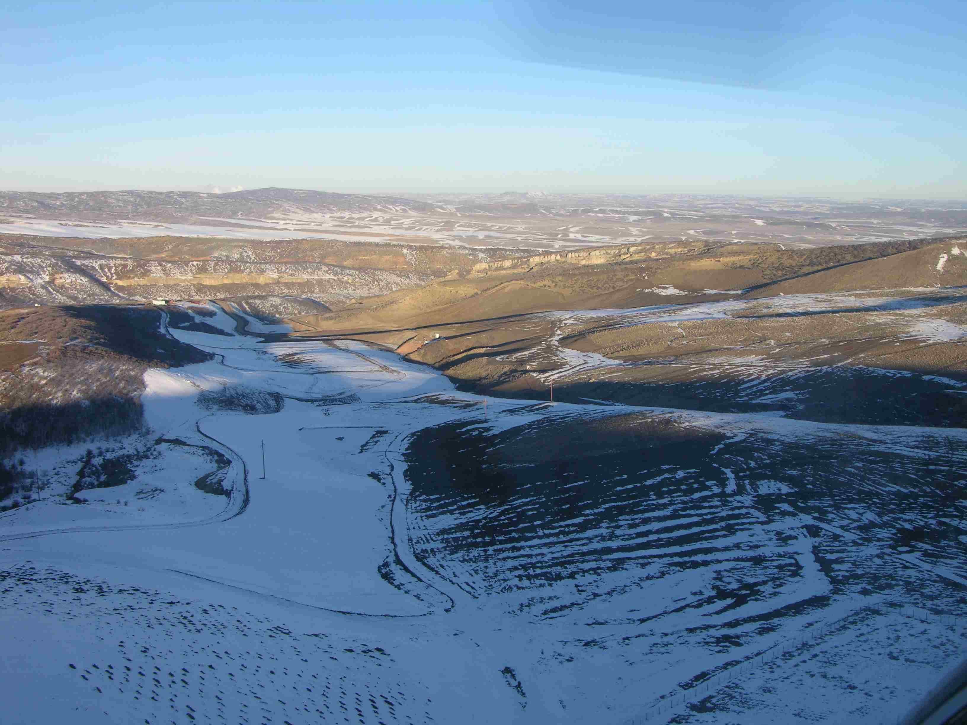 A pit in the winter after grading