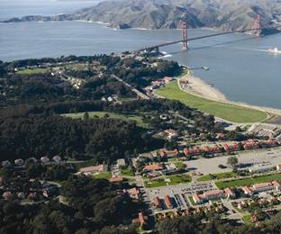 An aerial photo of the Main Post with the Golden Gate Bridge in the background.