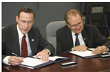 NOAA Administrator Conrad C. Lautenbacher, Jr. (left) and DOE Under Secretary for Science Dr. Raymond L. Orbach (right) at the signing of the MOU.