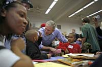 President George W. Bush greets volunteers big and small during Martin Luther King, Jr. Day at Cardozo Senior High School in Washington, D.C., Monday, Jan. 15, 2007. "One of the things that Mrs. King wanted was for MLK Day to be a day of service. It is not a day off, but it's a day on," said the President. "And so I'm here at Cardozo High School to thank the hundreds of people who have showed up to serve the country by volunteering."