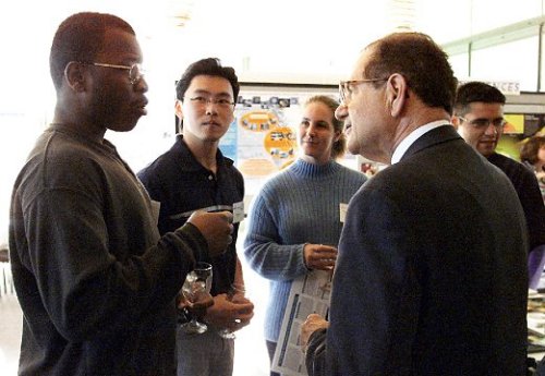Dr. Raymond Orbach (left), director of the Office of Science, listens to students, teachers, and their mentors