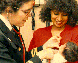 PHS doctor and child patient with mother