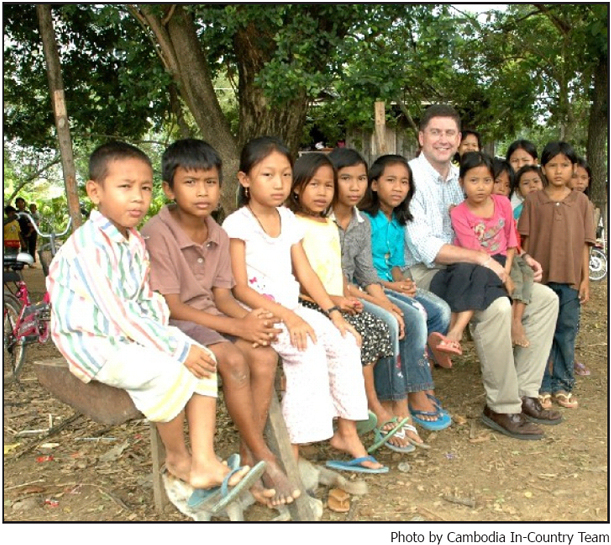 Jonathan Ross, USAID?s Acting Director of the Office of Public Health, pictured with children from the Battambang Province.  Photo by Cambodia In-Country Team.