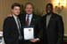 John Bridgeland, assistant to the president and director, USA Freedom Corps left, presents Bob Nardelli, chairman, president, and CEO of The Home Depot with a President's Volunteer Service Award following a swearing in ceremony for Nardelli and other members of the President's Council on Service and Civic Participation. Presenting the award with Bridgeland is former Washington Redskin Darrell Green, Council chair.