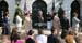 President George W. Bush stands for the national anthem with recipients of the President's Volunteer Service Award during Military Spouse Day ceremonies Tuesday, May 6, 2008, on the South Lawn of the White House.