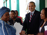 Minister of Health (Prof.) Sheila Tlou greets U.S. Embassy Deputy Chief of Mission, Philip Drouin, and members of BOMWA outside of the Maharaja Conference Centre in Gaborone before the seminar.