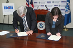 Assitant Security Julie Myers and Puerto Rico's Secretary of Correction and Rehabilitation, Miguel Pereira, signing a partnership agreement that will assist in ensuring that aliens serving criminal sentences are identified and processed for removal prior to their release from state custody
