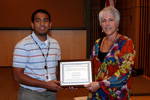 Enloe High School student Anand Kornepati, left, received his award from Charle League.