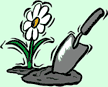 Image of a spade digging in soil next to a flower