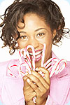 A woman holding candy canes.