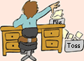 Image of person at a desk sorting papers between the file bin and toss bin
