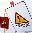 Two caution signs. (A yellow triangle with an exclamation point inside.)