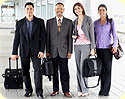 A group of business travelers, two women and two men.