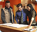 A man and woman looking at remodeling plans with a contractor.