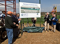 Partners preserve Maryland farmland. Secretary Schafer and NRCS Chief Arlen Lancaster (at right), landowner Glenn Elseroad (in orange cap at left), and State and local officials applaud the announcement of funding to protect hundreds of acres of Maryland farmland from development. USDA image.