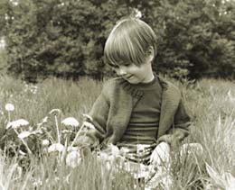 Photograph of girl in field of flowers