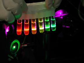 Image of Quantum dots suspended in PBS and placed into the 407nm Violet DPSS laser.