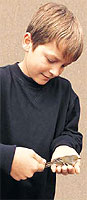 A young boy holding a bird. Ryan Hagerty; USFWS