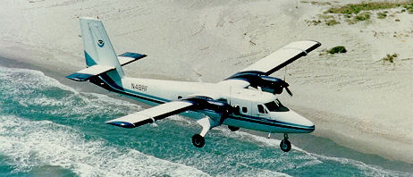Twin Otter Flying Over Beach