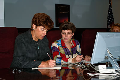 Photo showing USPTO experts 
			reviewing and responding to questions during an Inventors Online discussion.