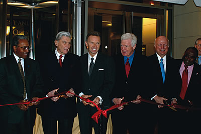 Photo showing ribbon cutting ceremony at the new USPTO Headquarters in Alexandria.  Preparing to cut the ribbon are: Stephen A. Perry, Administrator General Services Administration, Sen. John Warner, James E. Rogan, Former Under Secretary of the USPTO, Rep. James Moran, Samuel Bodman, Deputy Secretary of Commerce, and Mayor William D. Euille.