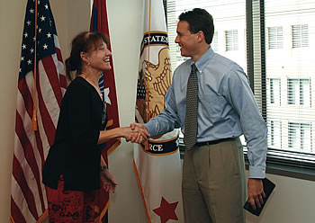 Photo showing Under Secretary Dudas congratulating Commissioner for Trademarks Lynne Beresford after swearing her in.