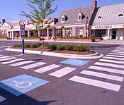 accessible parking spaces with stores in background
