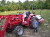 Abigale and Reece playing on a tractor at Shreveport Meteorologist in Charge Armando Garza's residence.